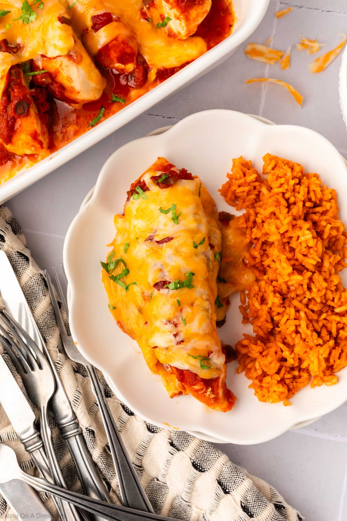 Baked chicken on a plate with spanish rice