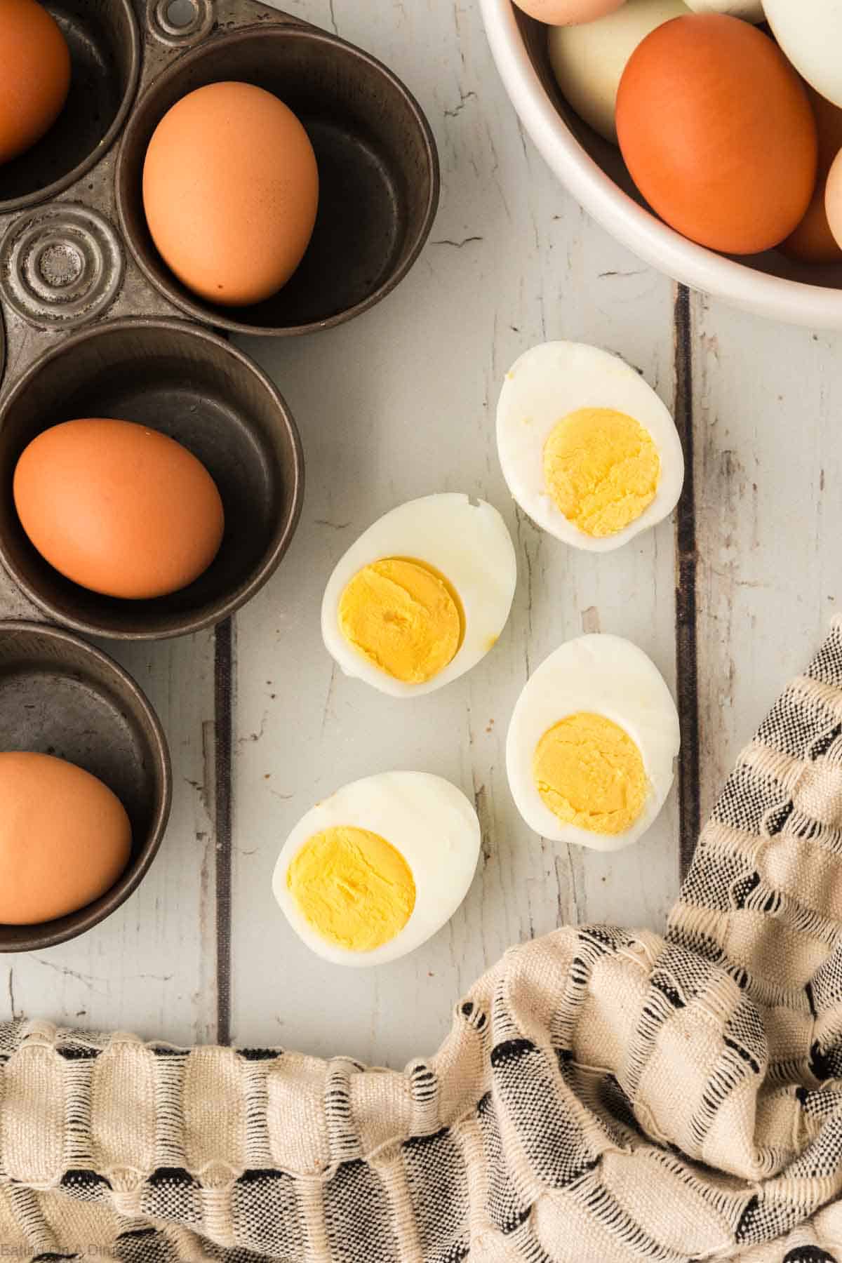 Close up image of hard boiled eggs and eggs in a muffin tin