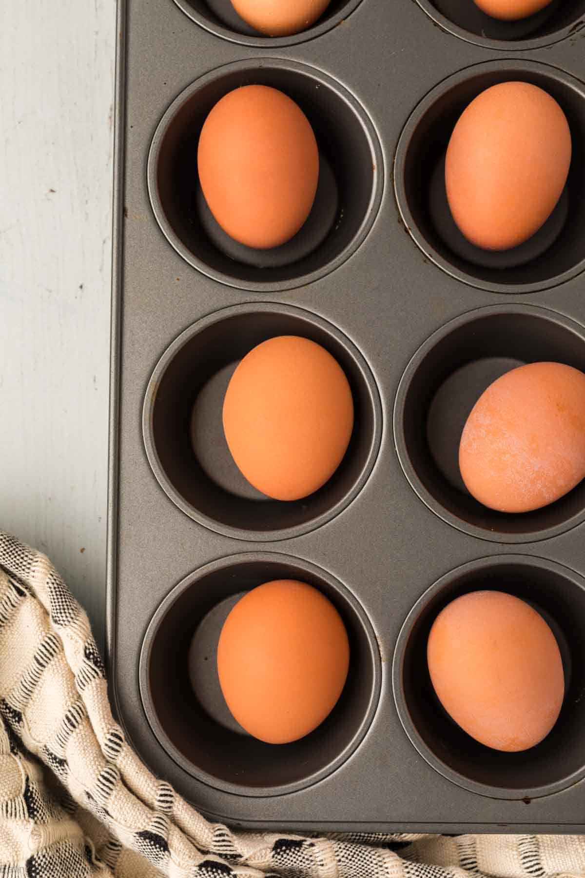 Placing eggs in a muffin tin