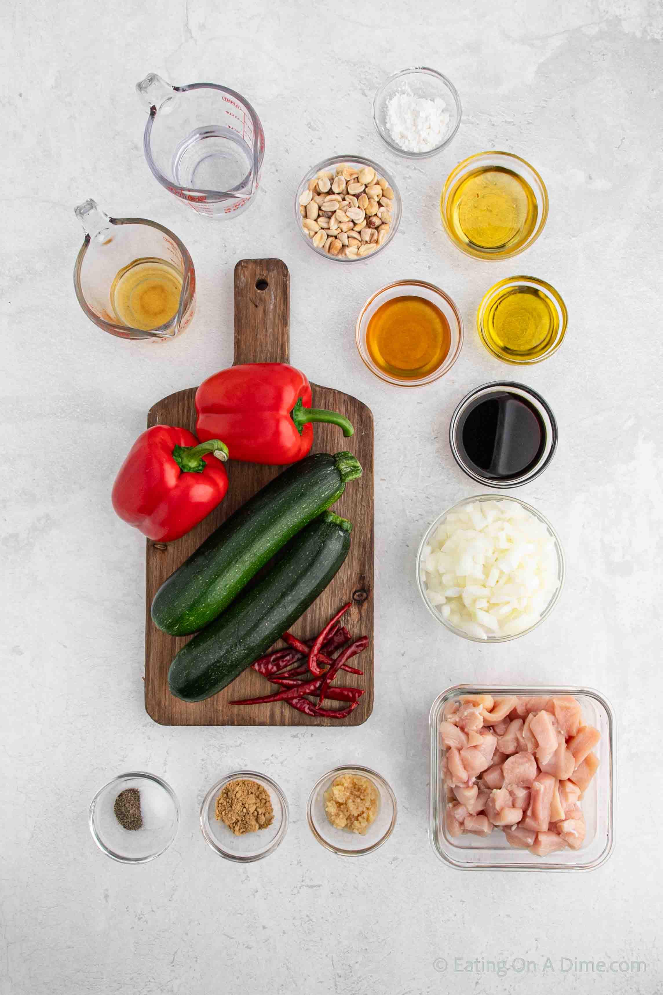 Kung Pao Chicken ingredients - chicken breasts, olive oil, soy sauce, sesame oil, water, rice vinegar, honey, onion, bell peppers, zucchini, garlic, ginger, pepper, salt, chili peppers, peanuts, cornstarch