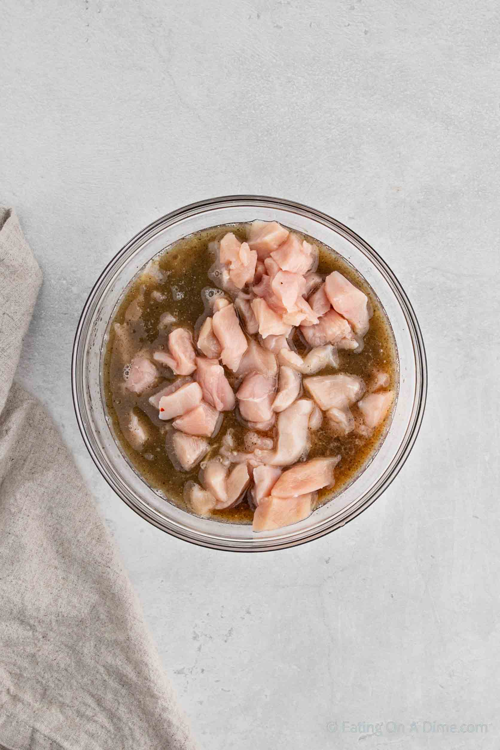 Marinating diced chicken in a bowl