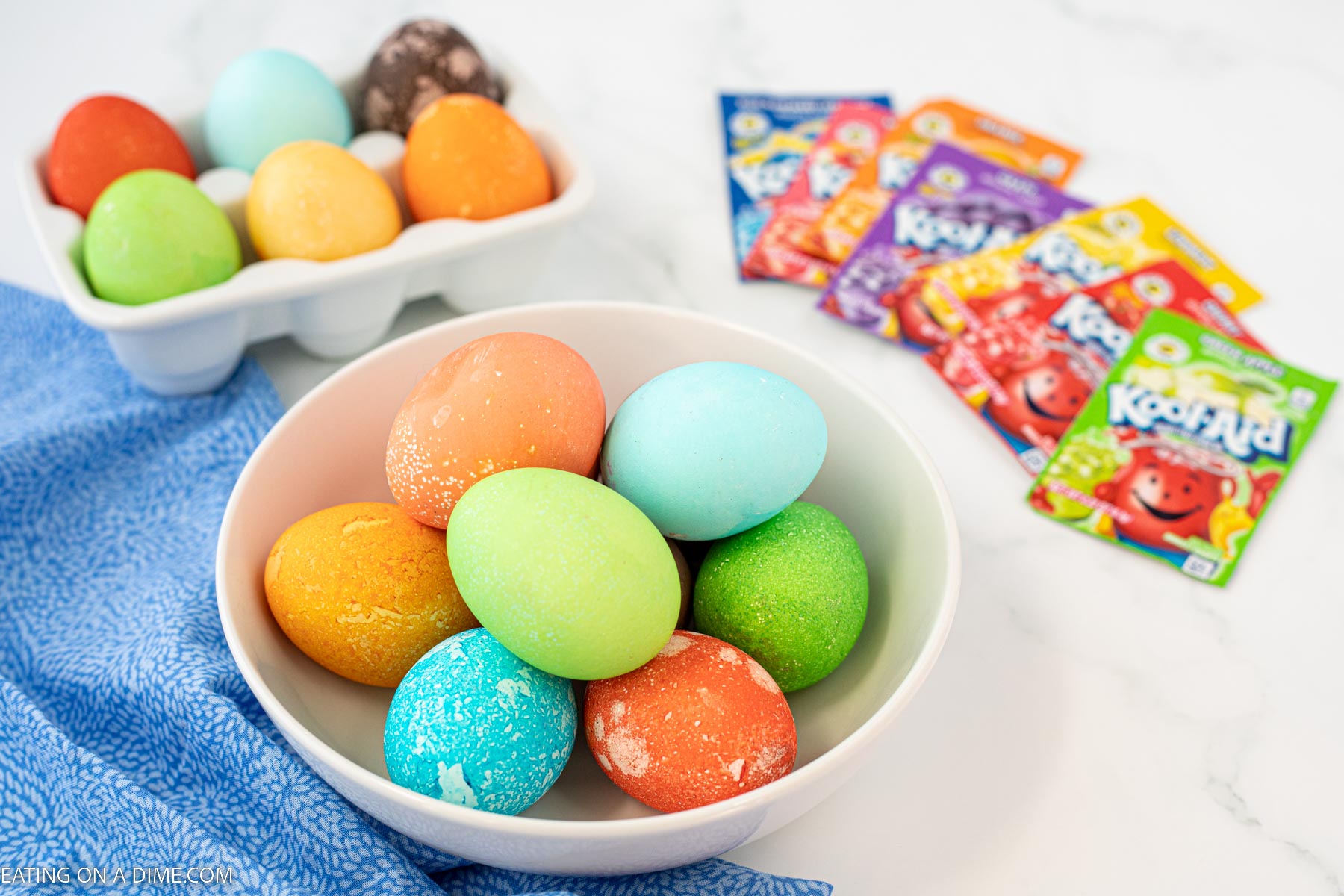 Dyed Easter Eggs in a bowl with koolaid packets