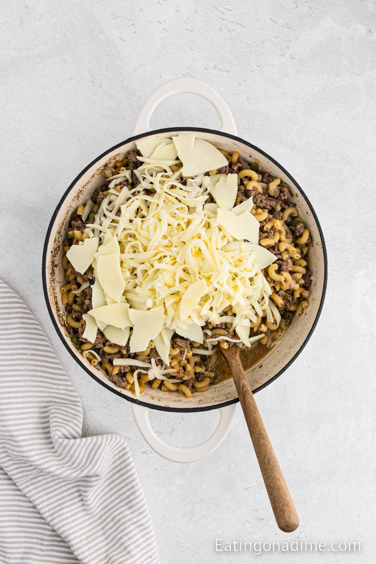 Adding the cheese in the cooked pasta mixture