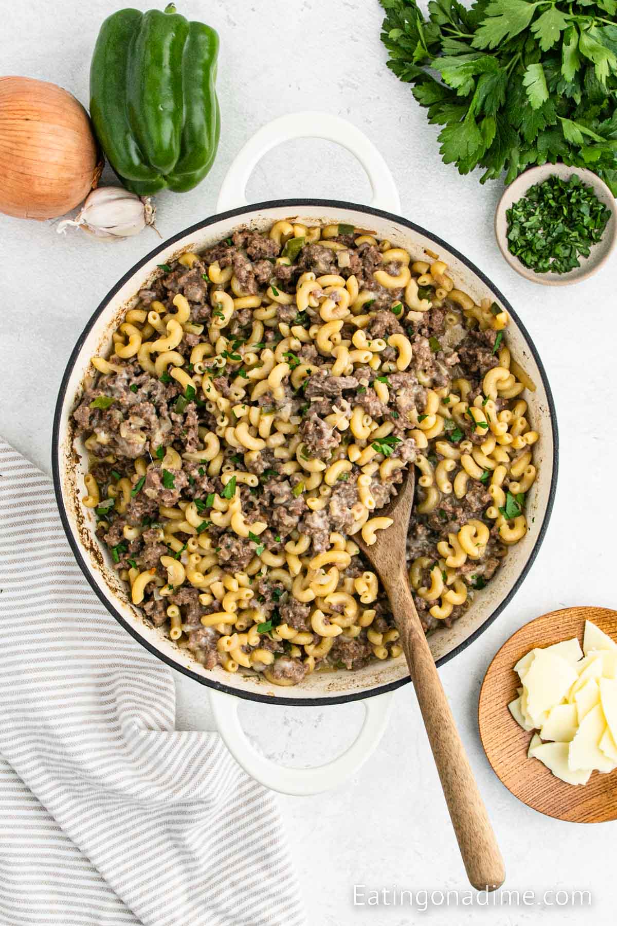 Stirring the ingredients together in a skillet with a wooden spoon