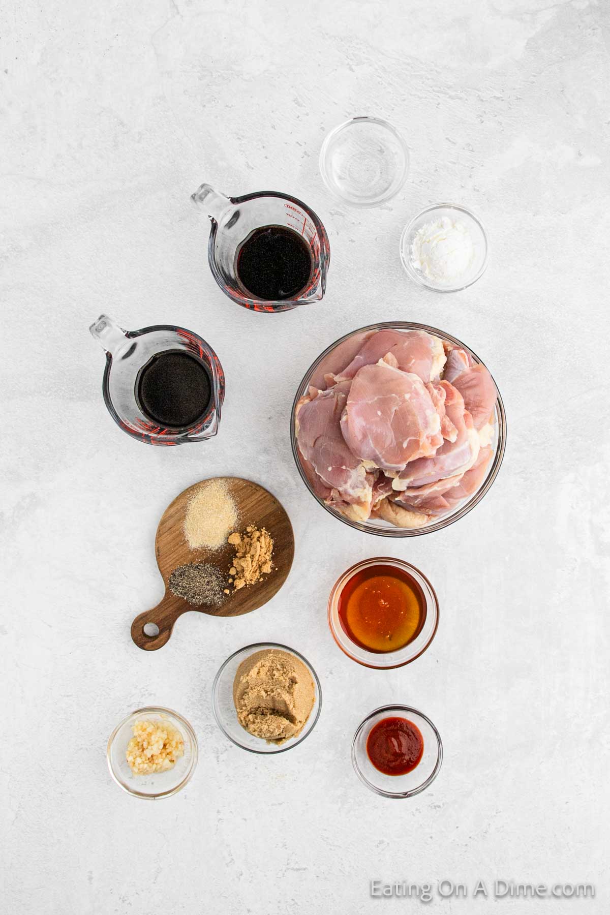 Ingredients - chicken thighs, soy sauce, balsamic vinegar, brown sugar, honey, minced garlic, ginger, sriracha sauce, onion powder, pepper, cornstarch, water, green onions, sesame seeds