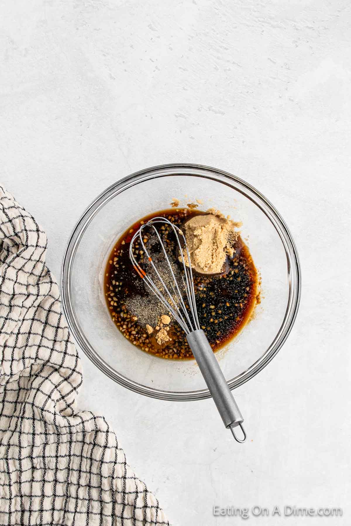Combining the marinade ingredients in a bowl with a whisk