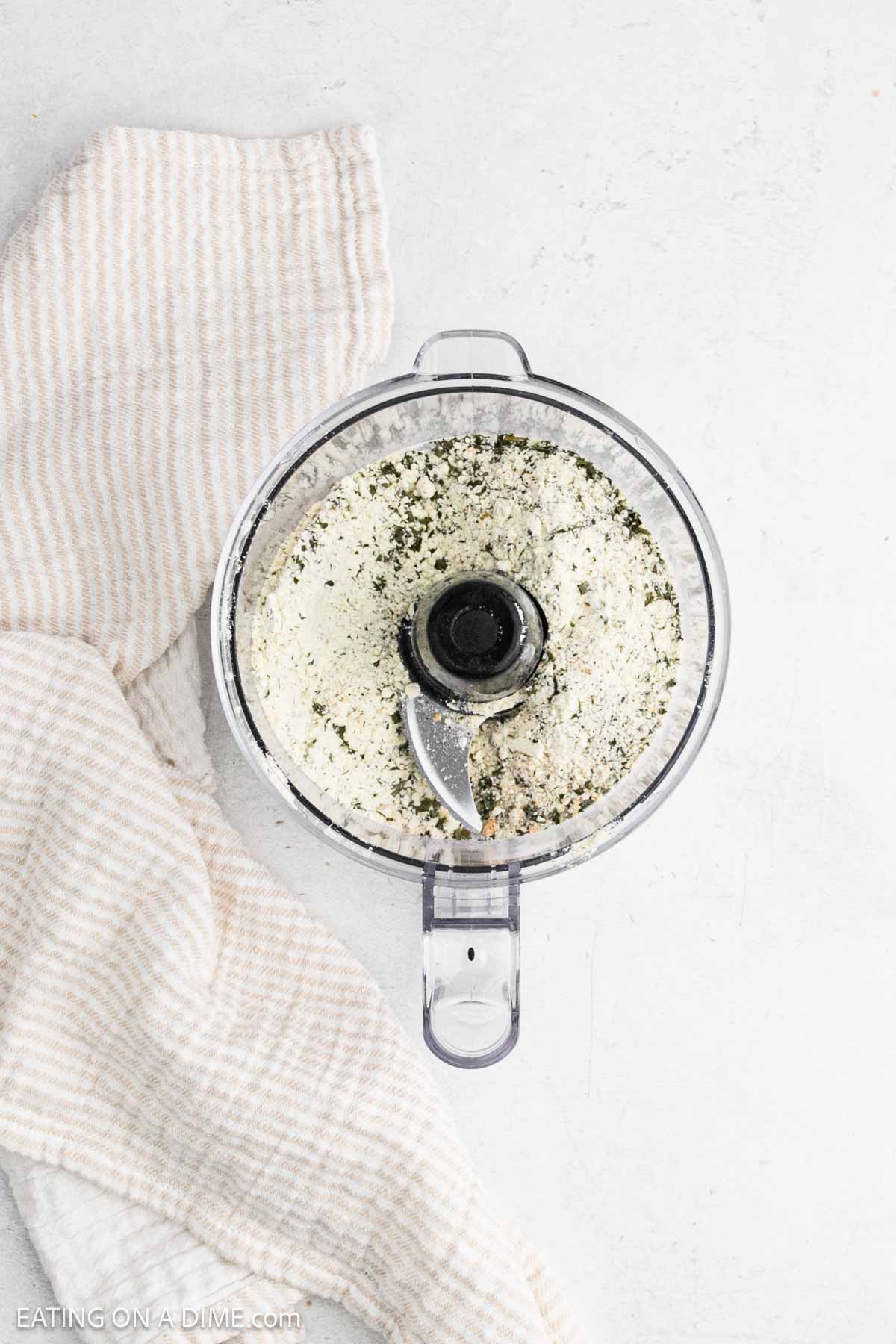 Using the food processor to combine the spices.