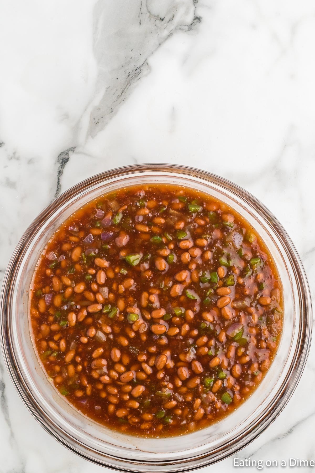 Adding in the baked beans into the BBQ sauce mixture