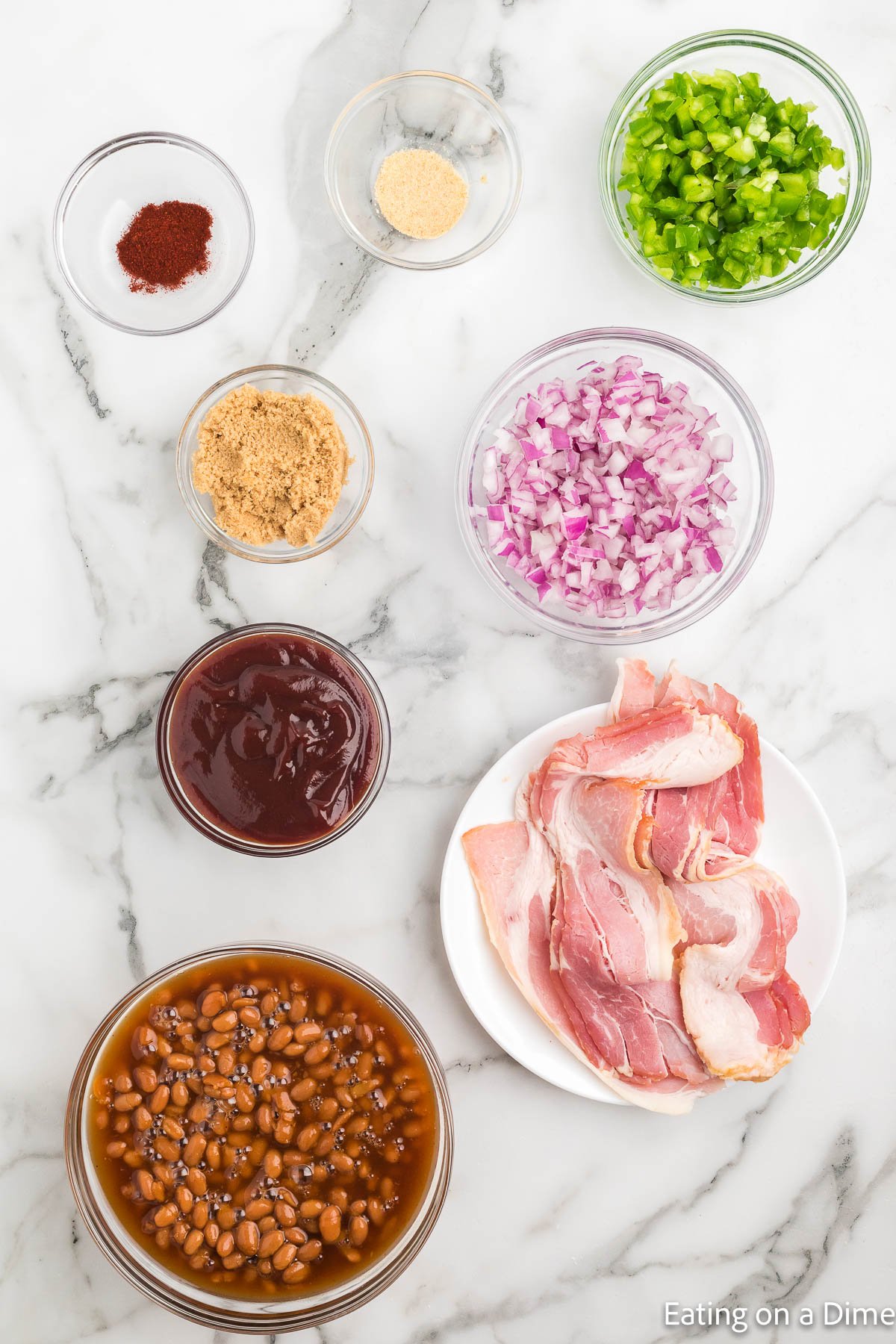 Baked Beans Ingredients - baked beans, barbecue sauce, brown sugar, paprika, garlic powder, red onion, bell pepper, bacon