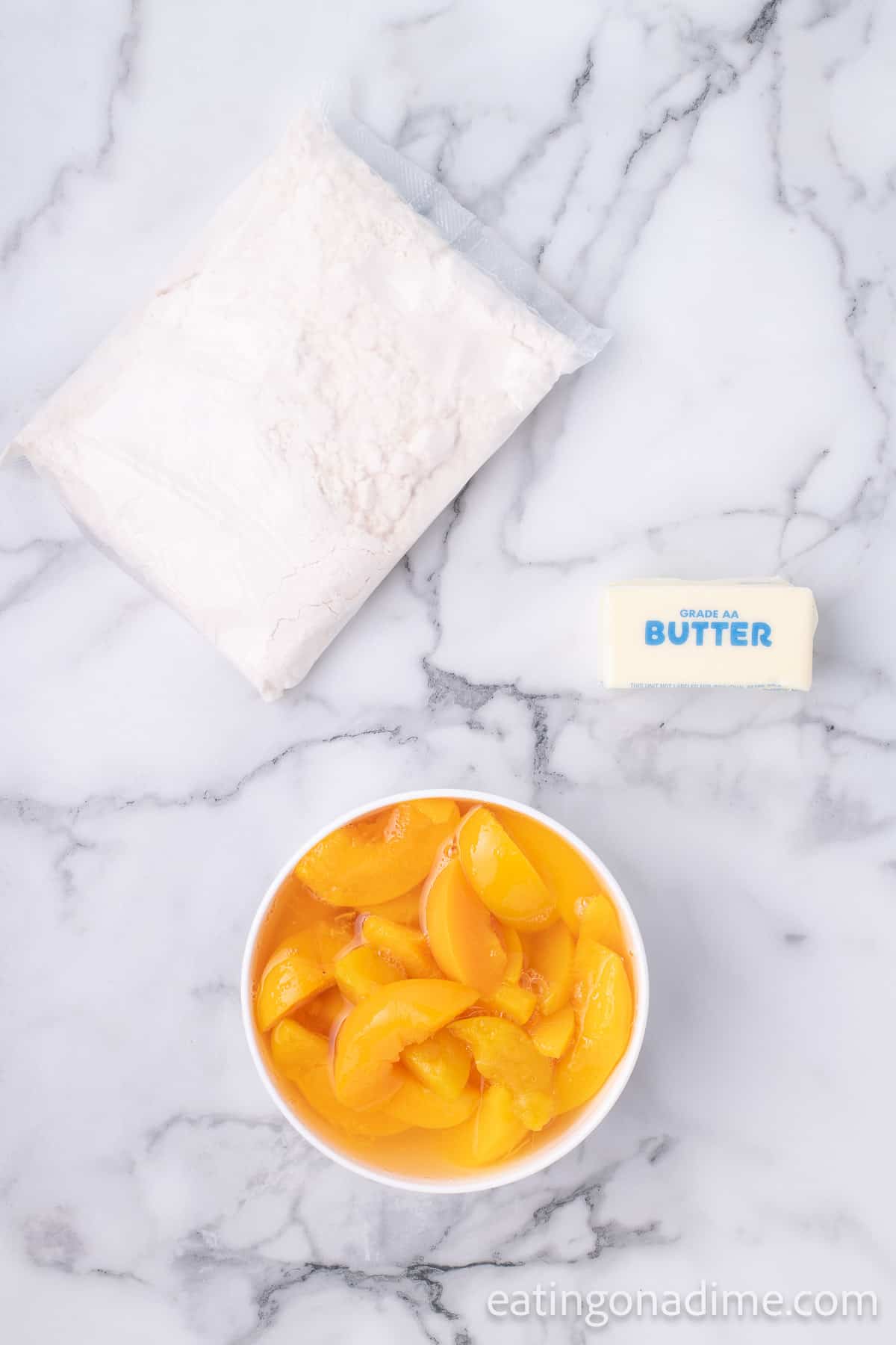 Ingredients for Crock Pot Peach Dump Cake: Canned peaches in Heavy Syrup, Yellow Cake Mix and Butter