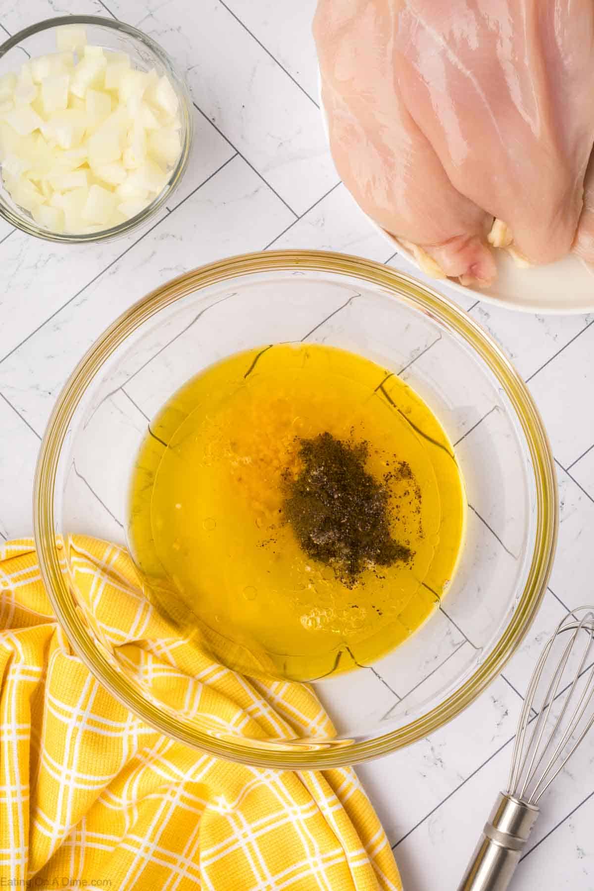 Combining the lemon marinade ingredients in a bowl