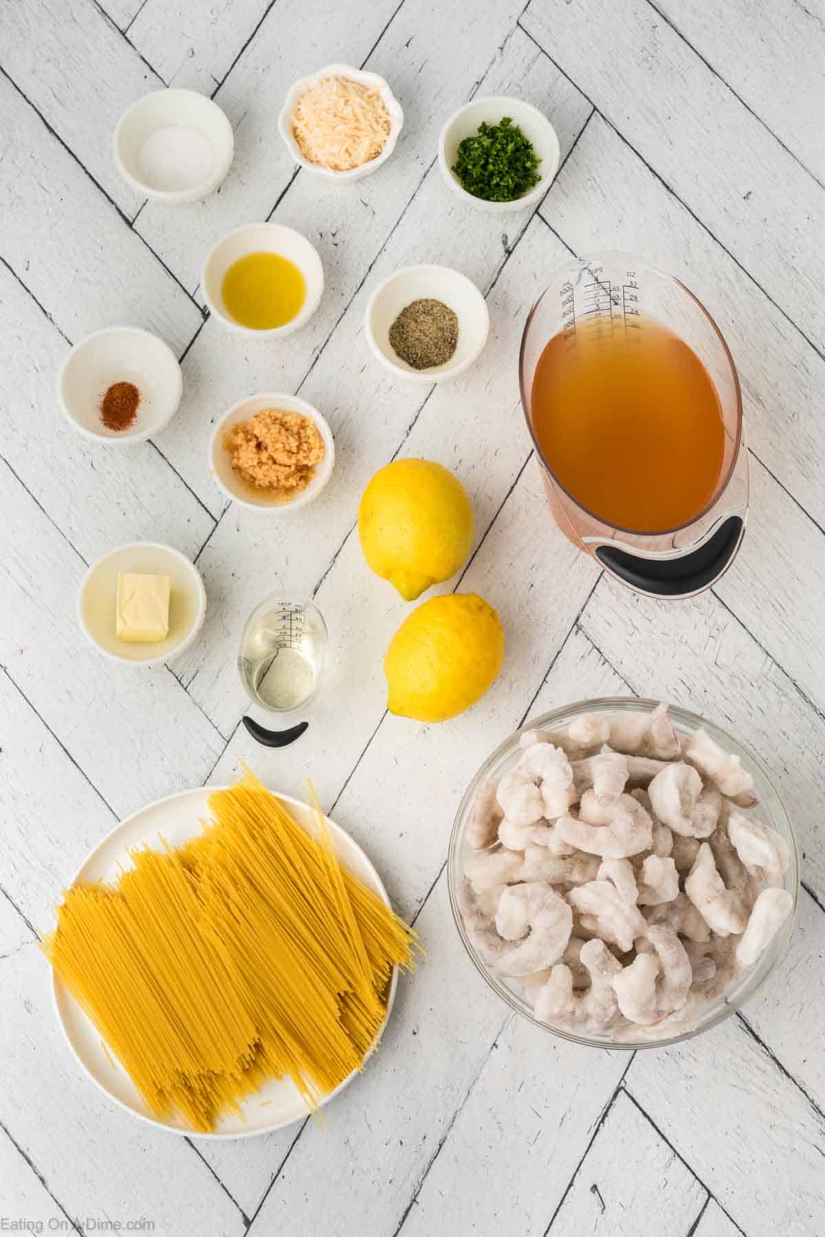 Shrimp Scampi ingredients - butter, olive oil, garlic, white wine, chicken broth, lemons, cayenne pepper, salt, pepper, pasta, shrimp, parsley, parmesan cheese