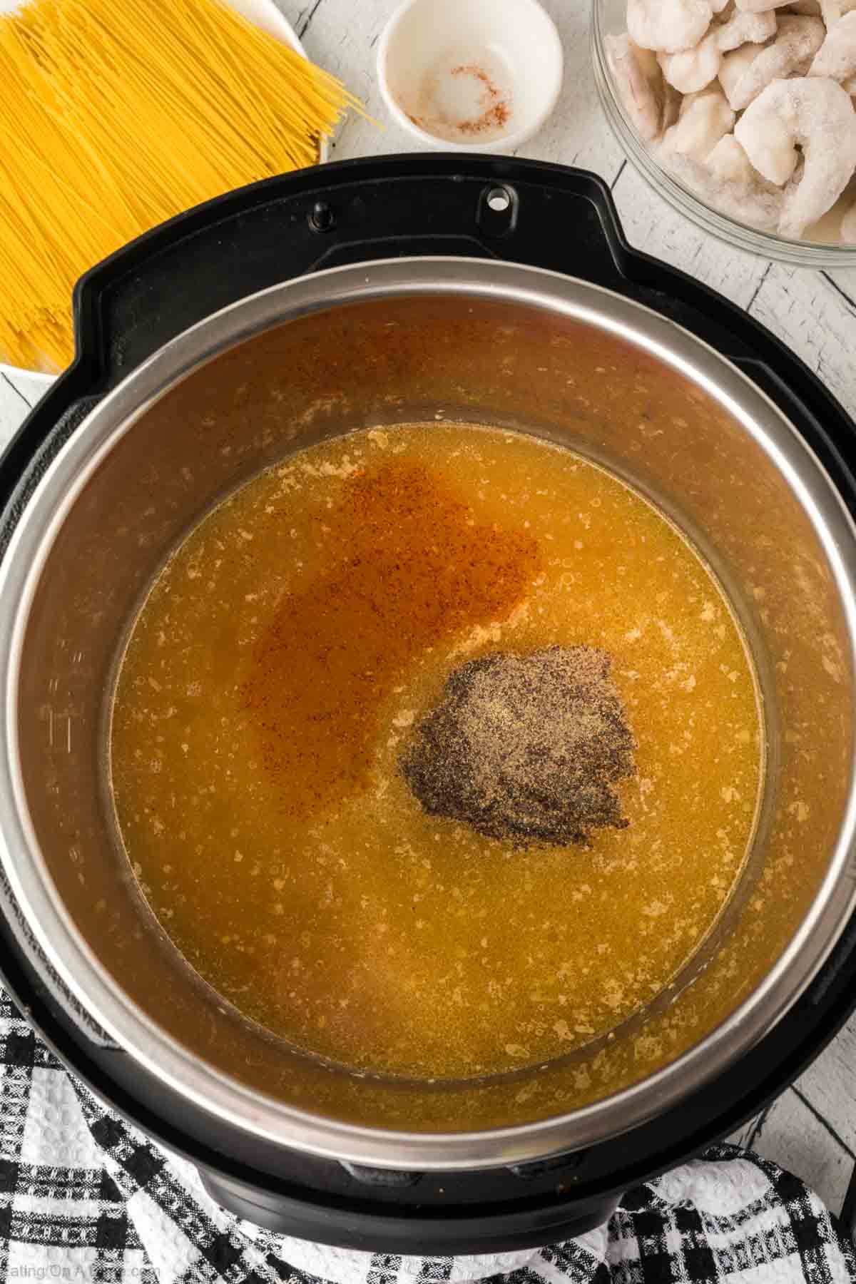 Adding the seasoning to the broth mixture in the instant pot