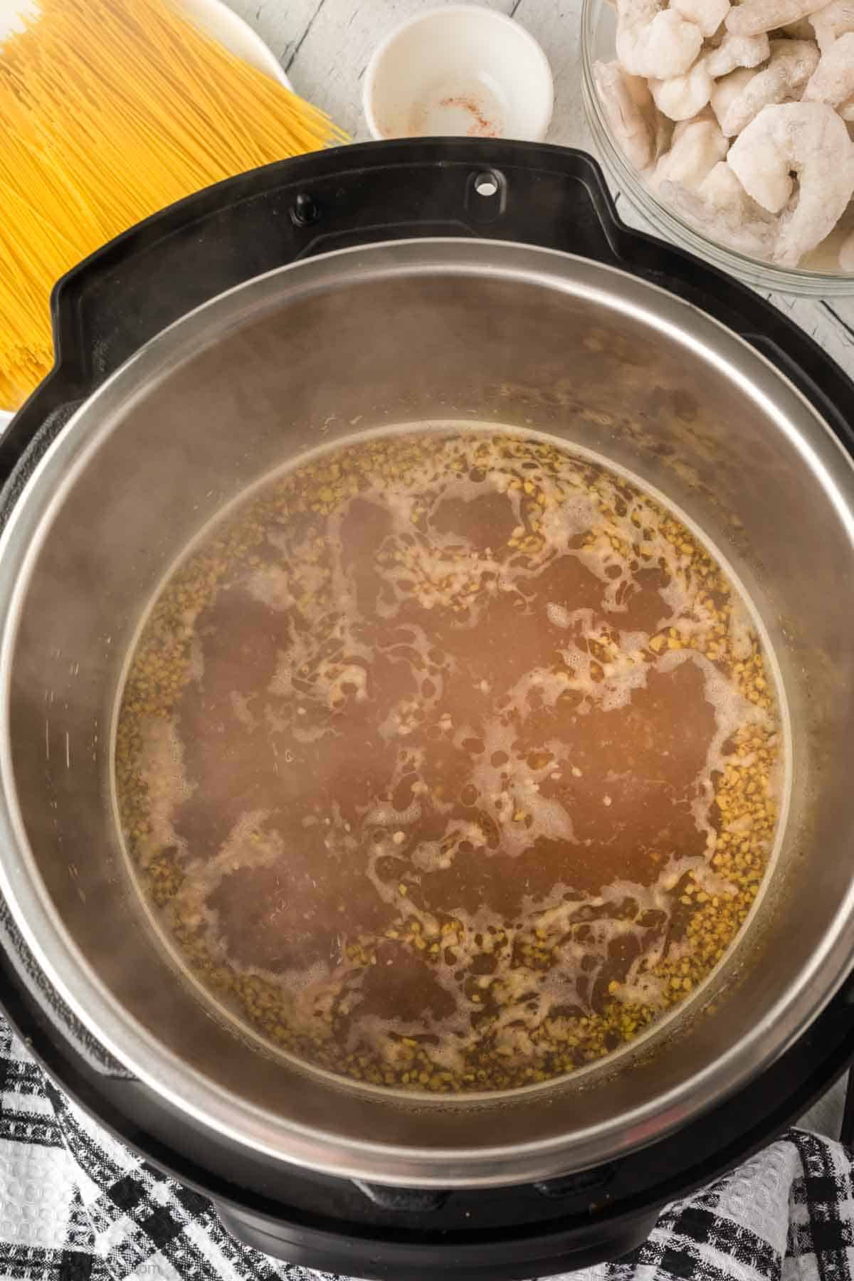 Adding the white wine to the instant pot