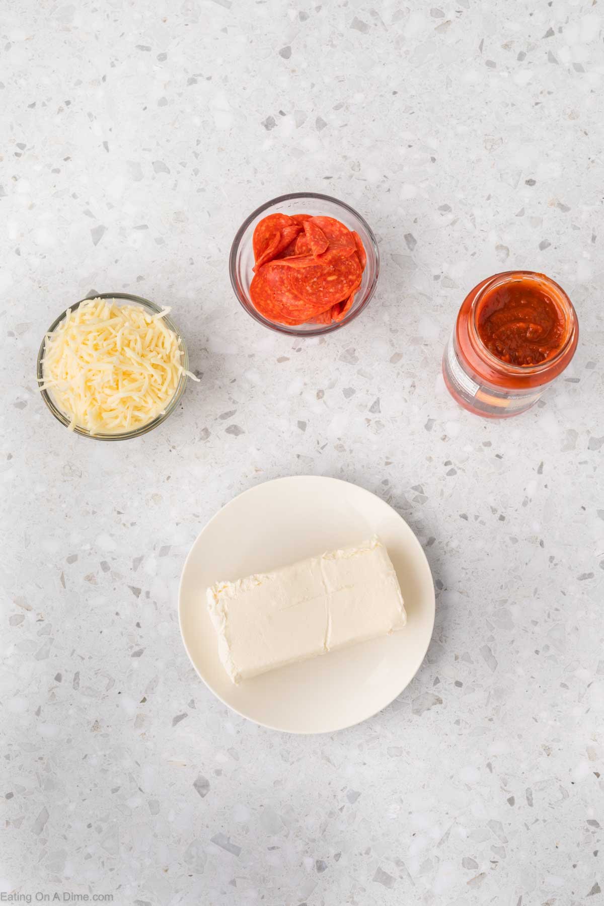 Pizza Dip ingredients - cream cheese, pizza cheese, pasta sauce, pepperoni, seasoning