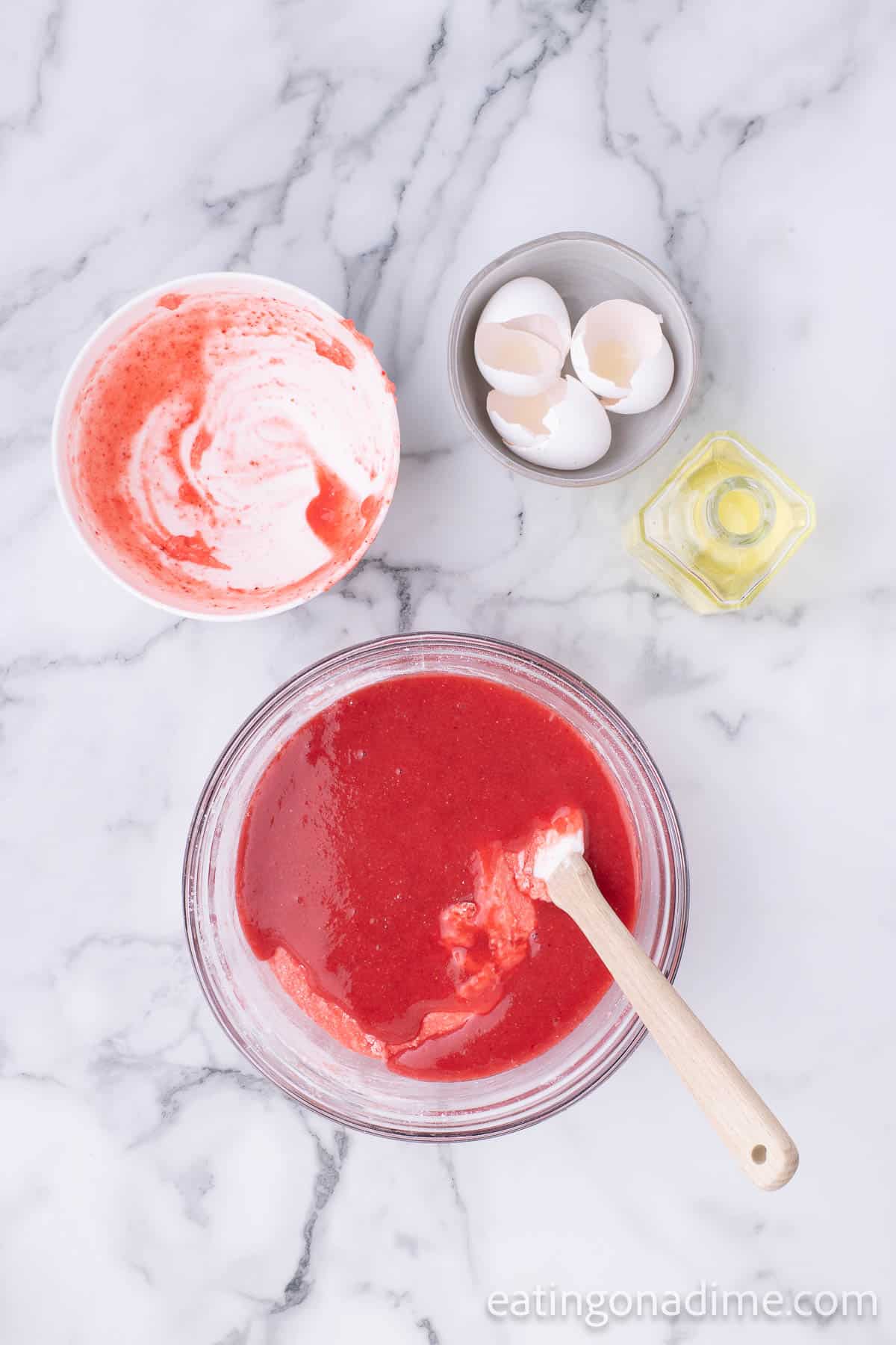 Add in the puree strawberries into the dry ingredients with the egg and oil