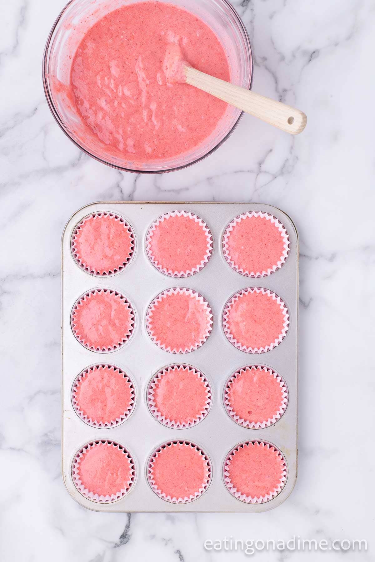 Divide the strawberry cake mix batter into the muffin tin