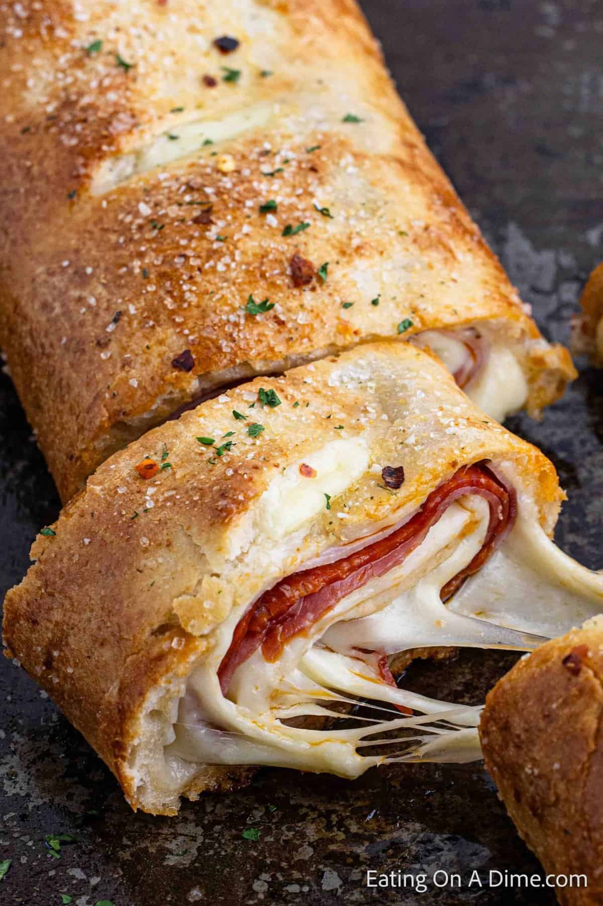 Close up image of stromboli sliced with melty cheese