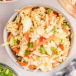 Enjoy this easy ramen noodle salad recipe featuring shredded cabbage, carrots, green onions, and red bell peppers, all tossed in a light dressing for a refreshing and flavorful dish.