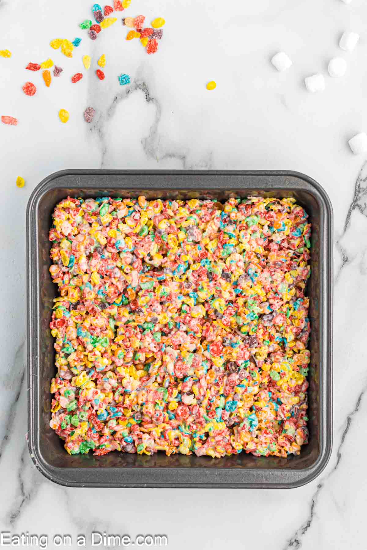 Fruity Pebbles mixture pressed into a baking dish