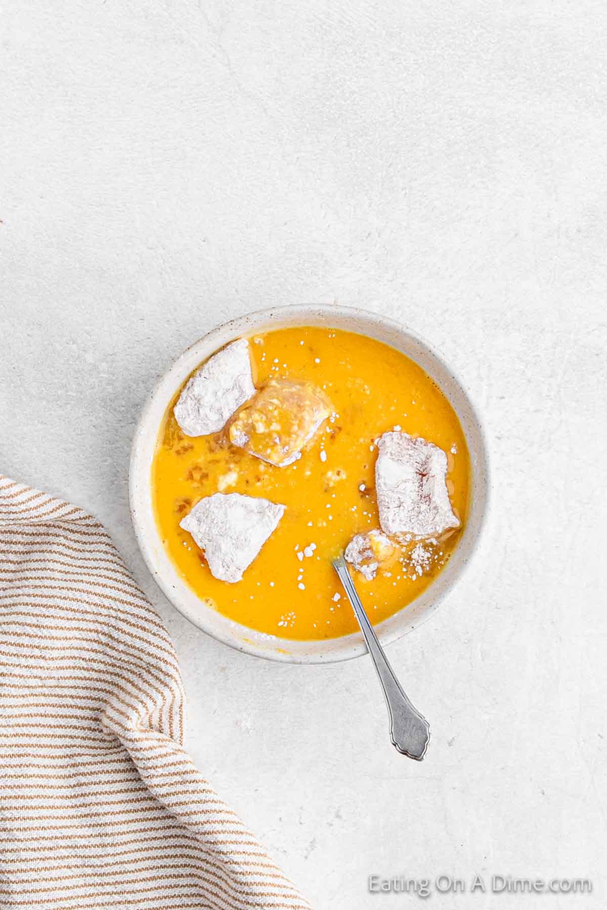 Beat eggs in a bowl and then adding the flour chicken