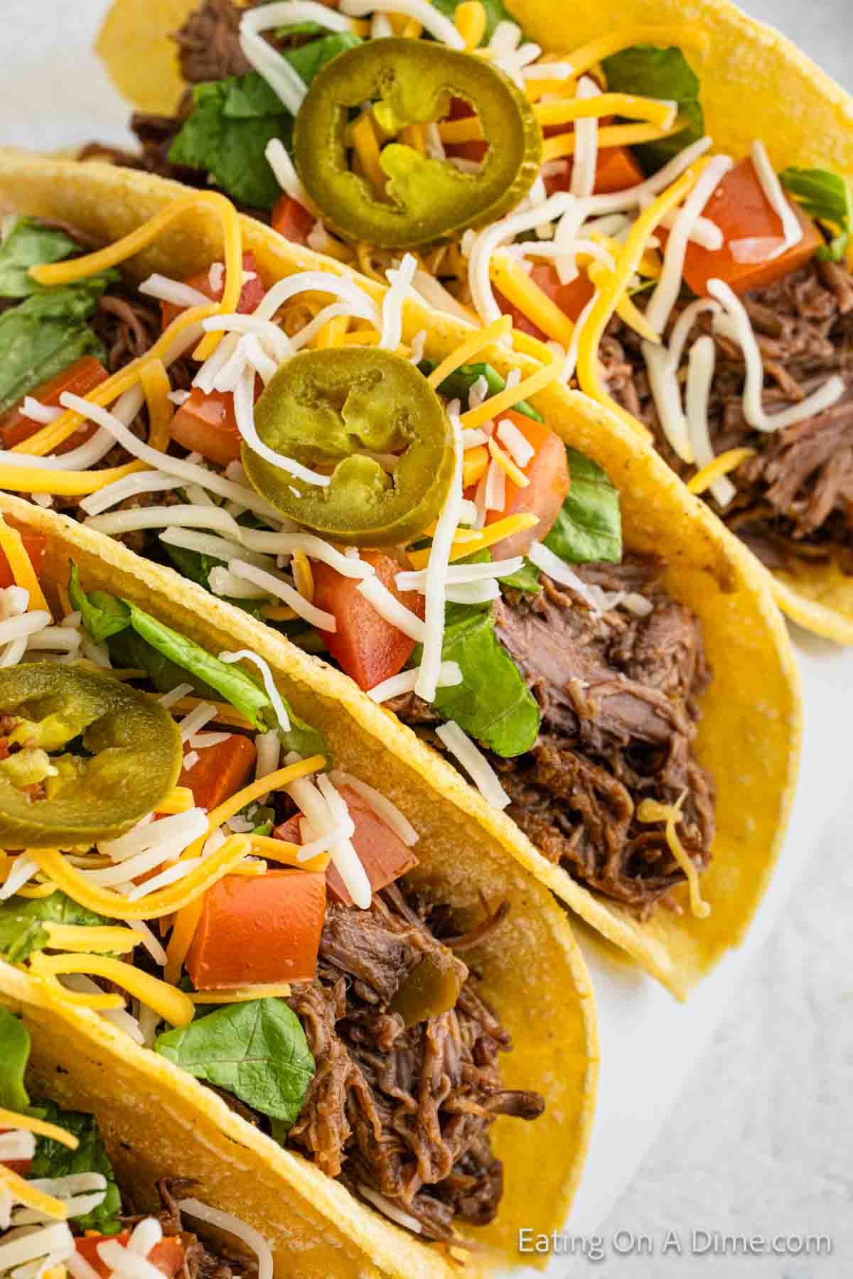 Close up image of shredded beef tacos on a plate