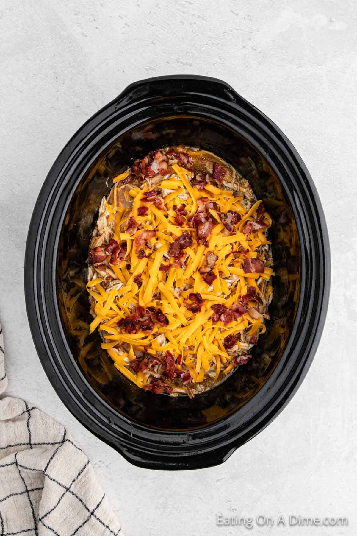 Top with shredded cheese and chopped bacon