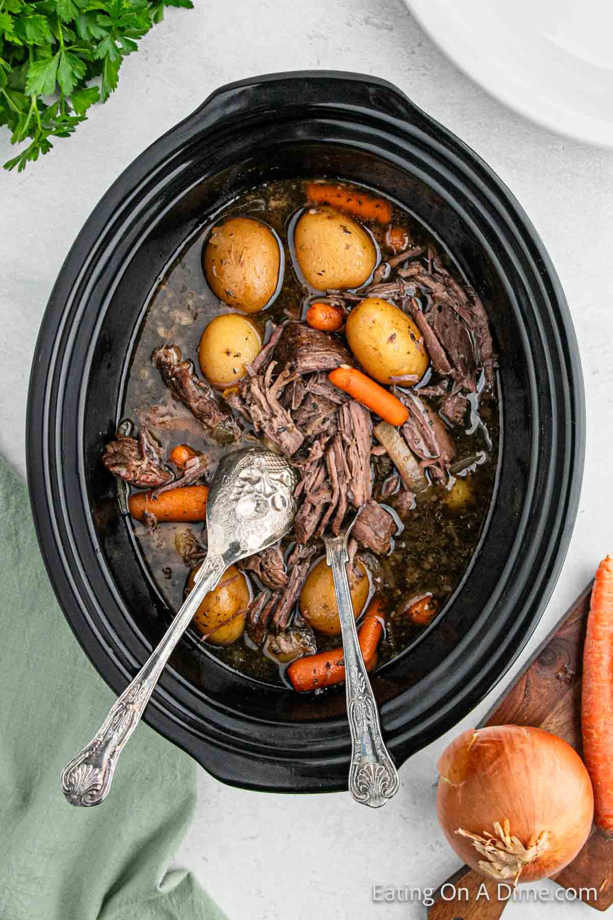 Cooked pot roast in the slow cooker with the veggies 