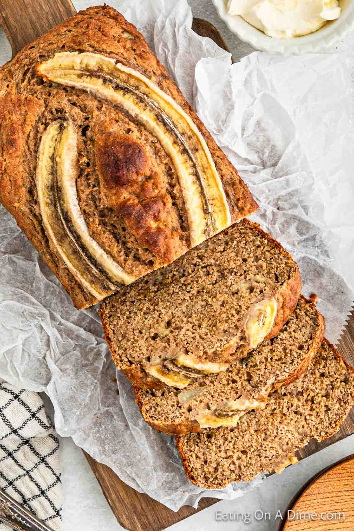 Banana Bread sliced on a piece of parchment paper