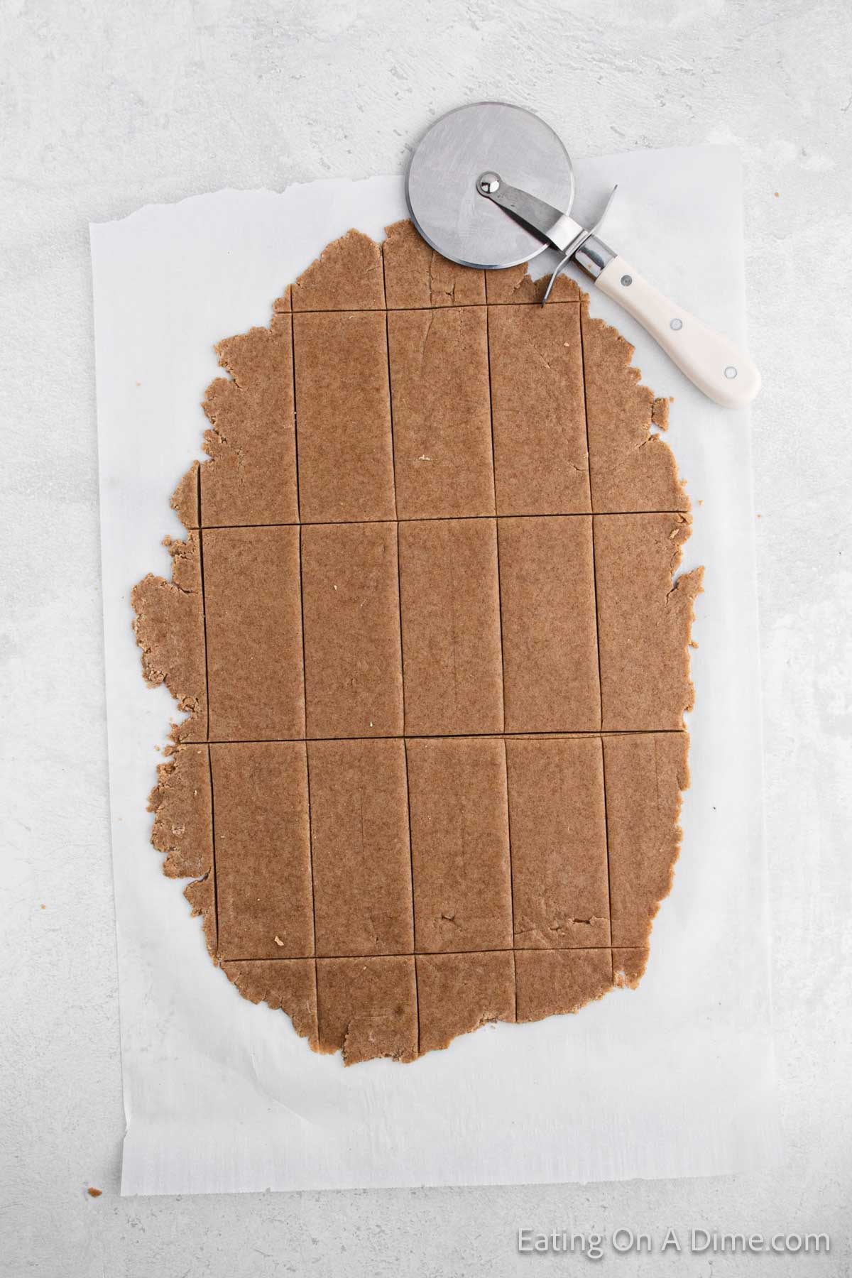 Cutting dough into rectangle shape with a pizza cutter