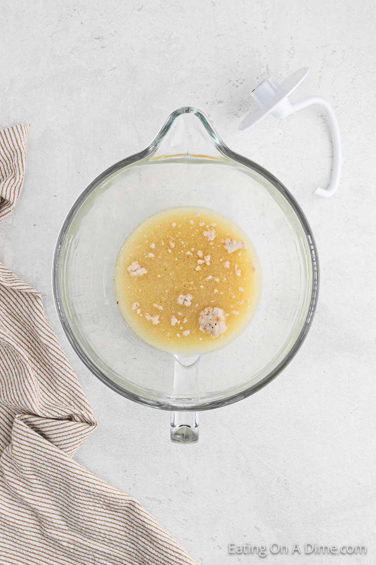 Combining yeast, brown sugar, water and butter in a bowl