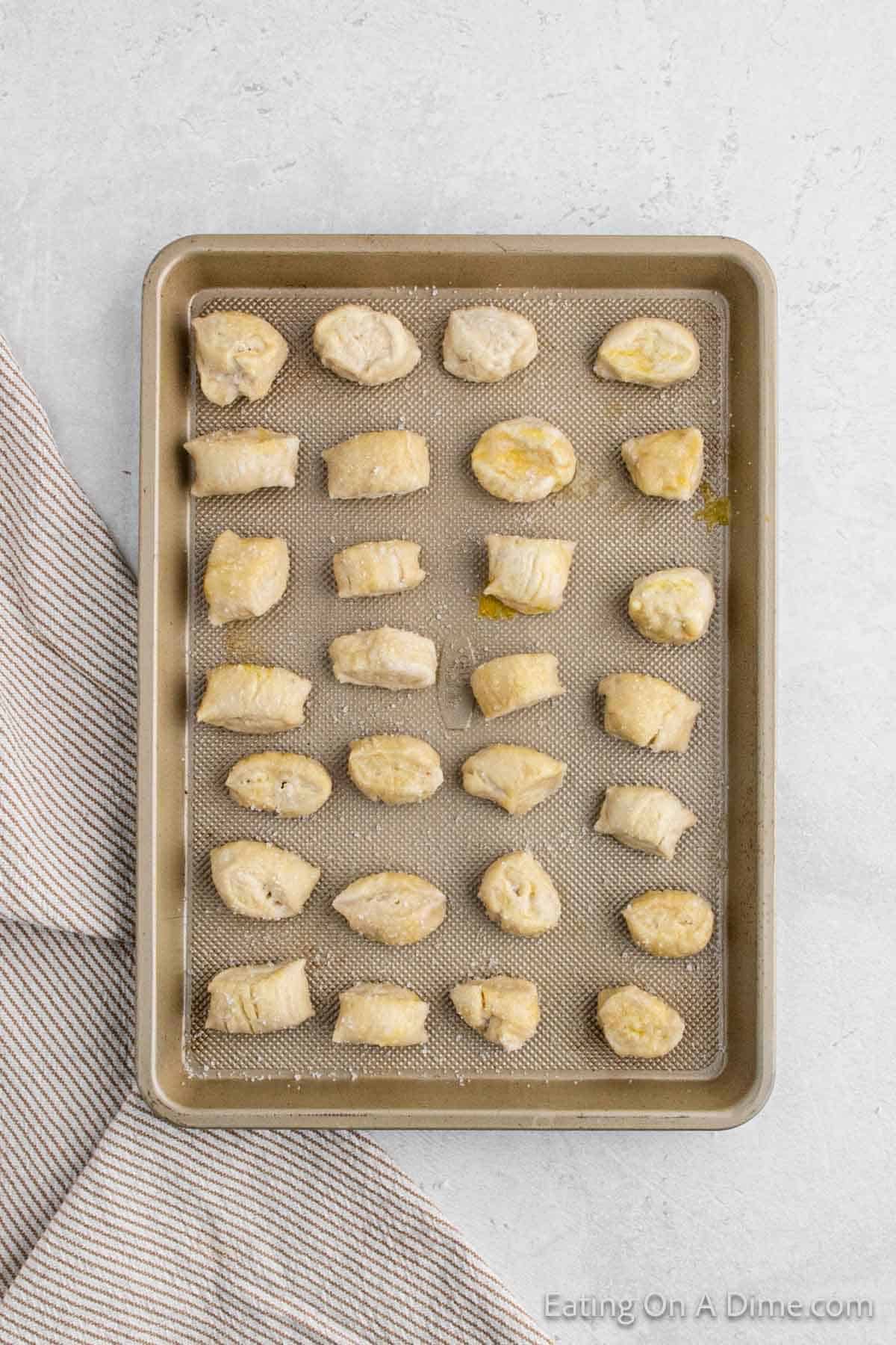 Placing the cooked dough pieces on a baking sheet