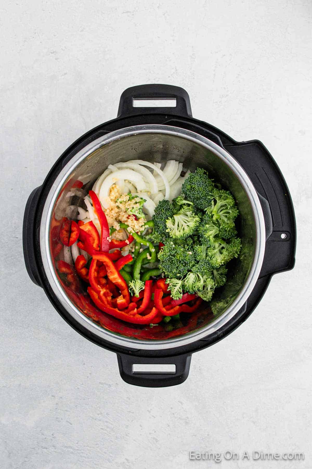 Adding in the broccoli, red peppers and onions in the instant pot