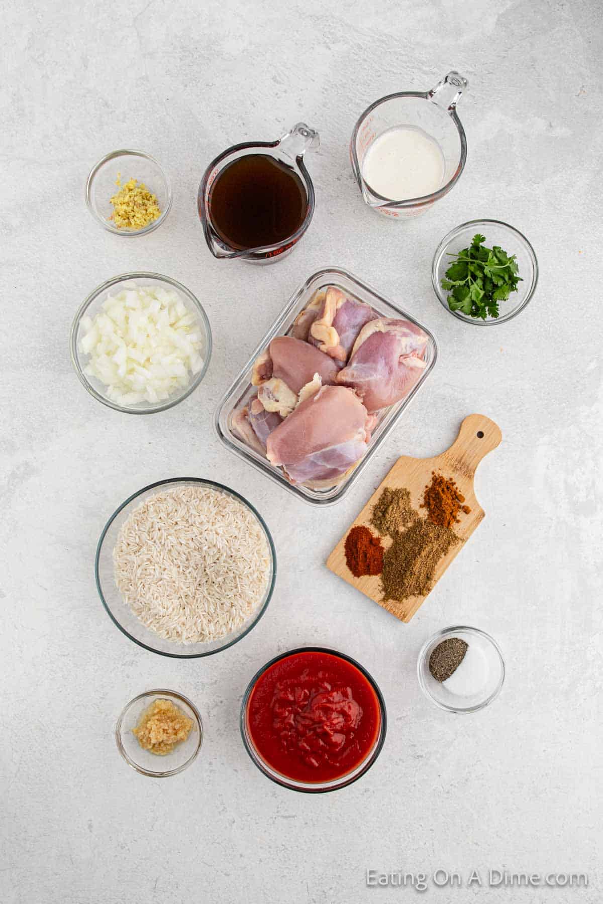 Chicken Tikka Masala Ingredients - chicken thighs, garam masala, cumin, turmeric, paprika, salt, pepper, onion, garlic, ginger, tomato sauce, chicken broth, heavy cream, rice, cilantro