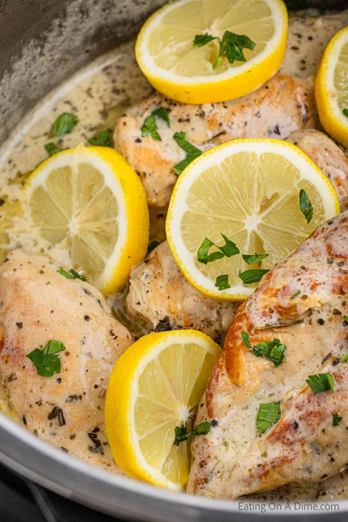 Close up image of lemon chicken with slices of fresh lemons