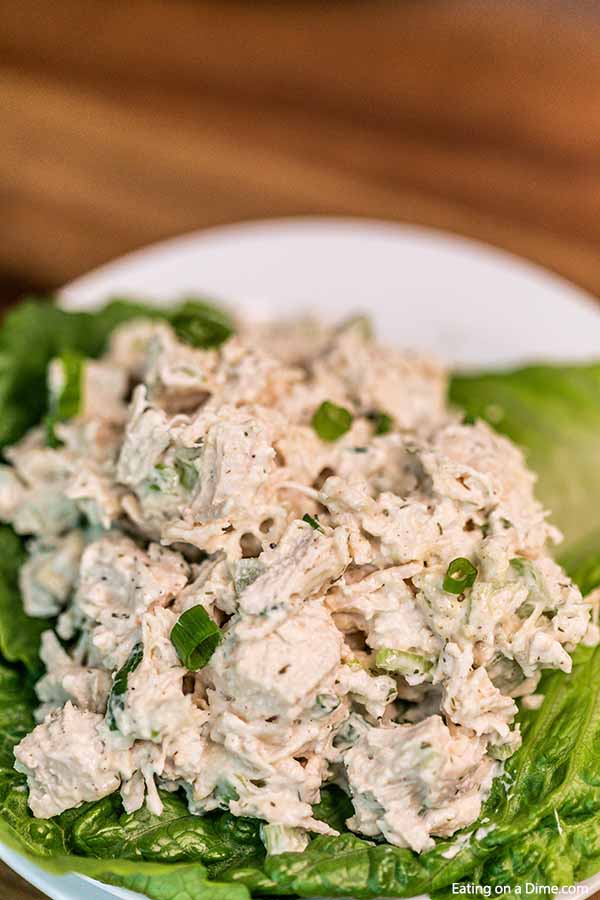 Close up image of chicken salad on a bed of lettuce. 
