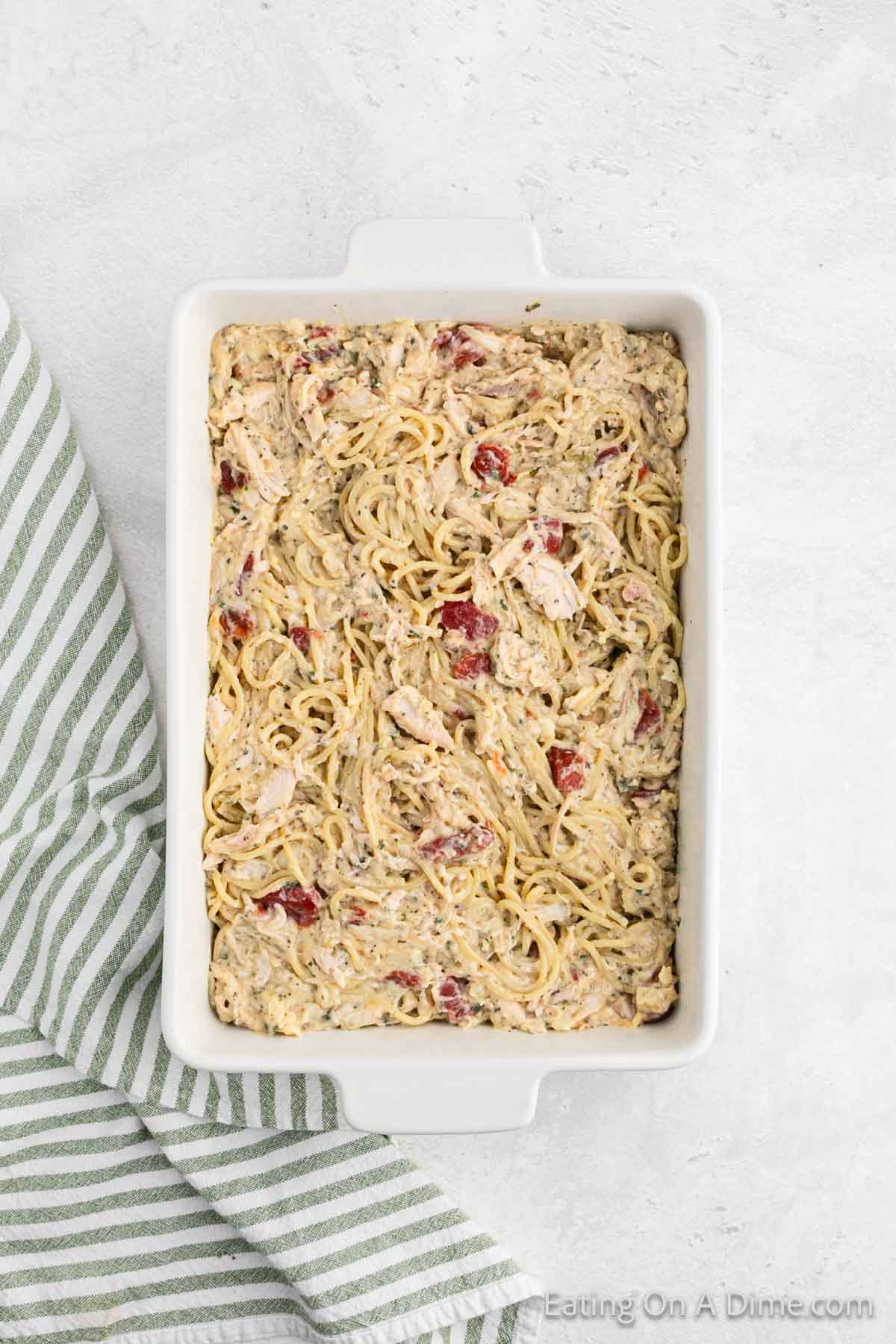 Chicken spaghetti casserole spread into baking dish