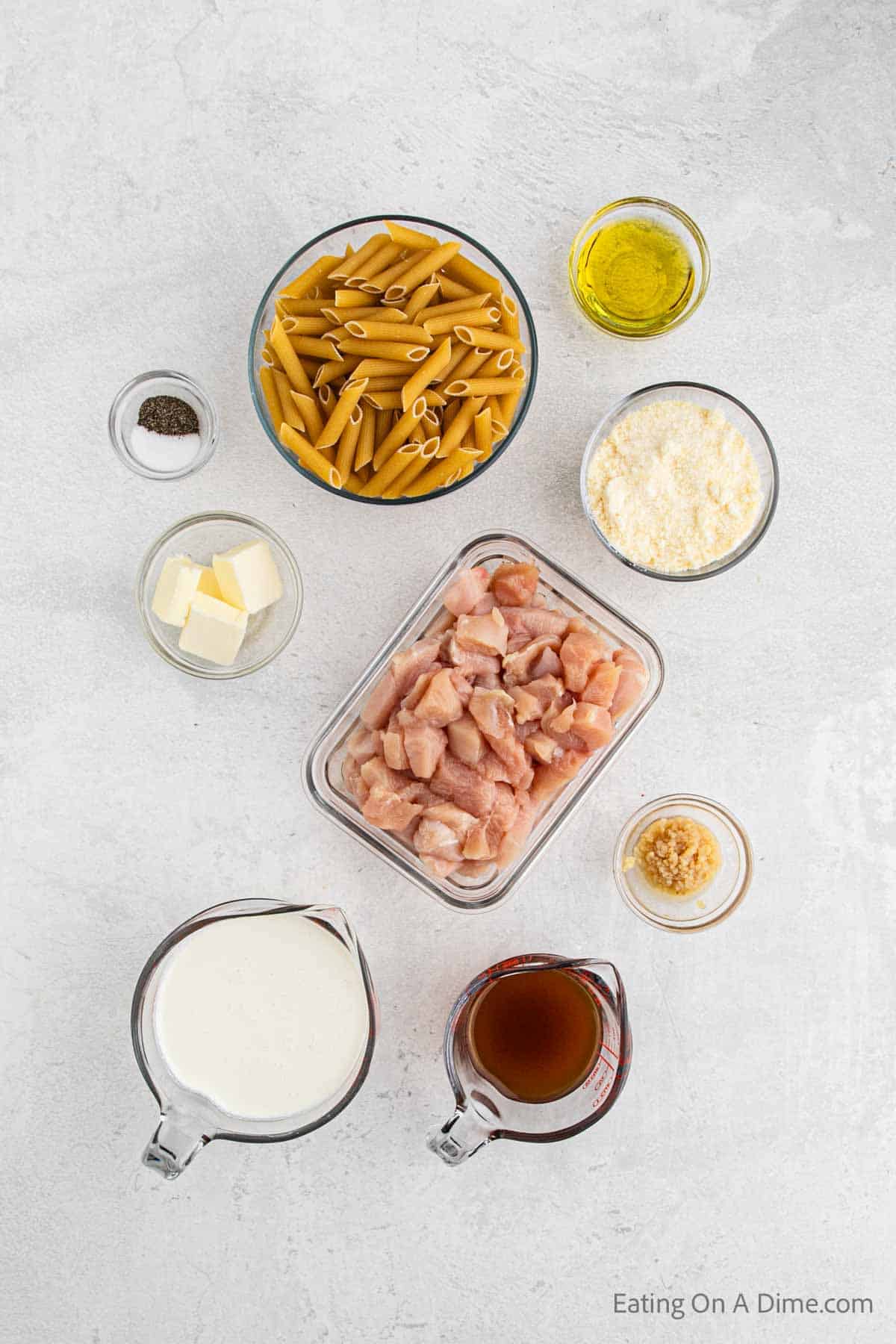 Ingredients for chicken penne pasta - chicken, olive oil, salt and pepper, garlic butter, heavy cream, broth, parmesan cheese, pasta