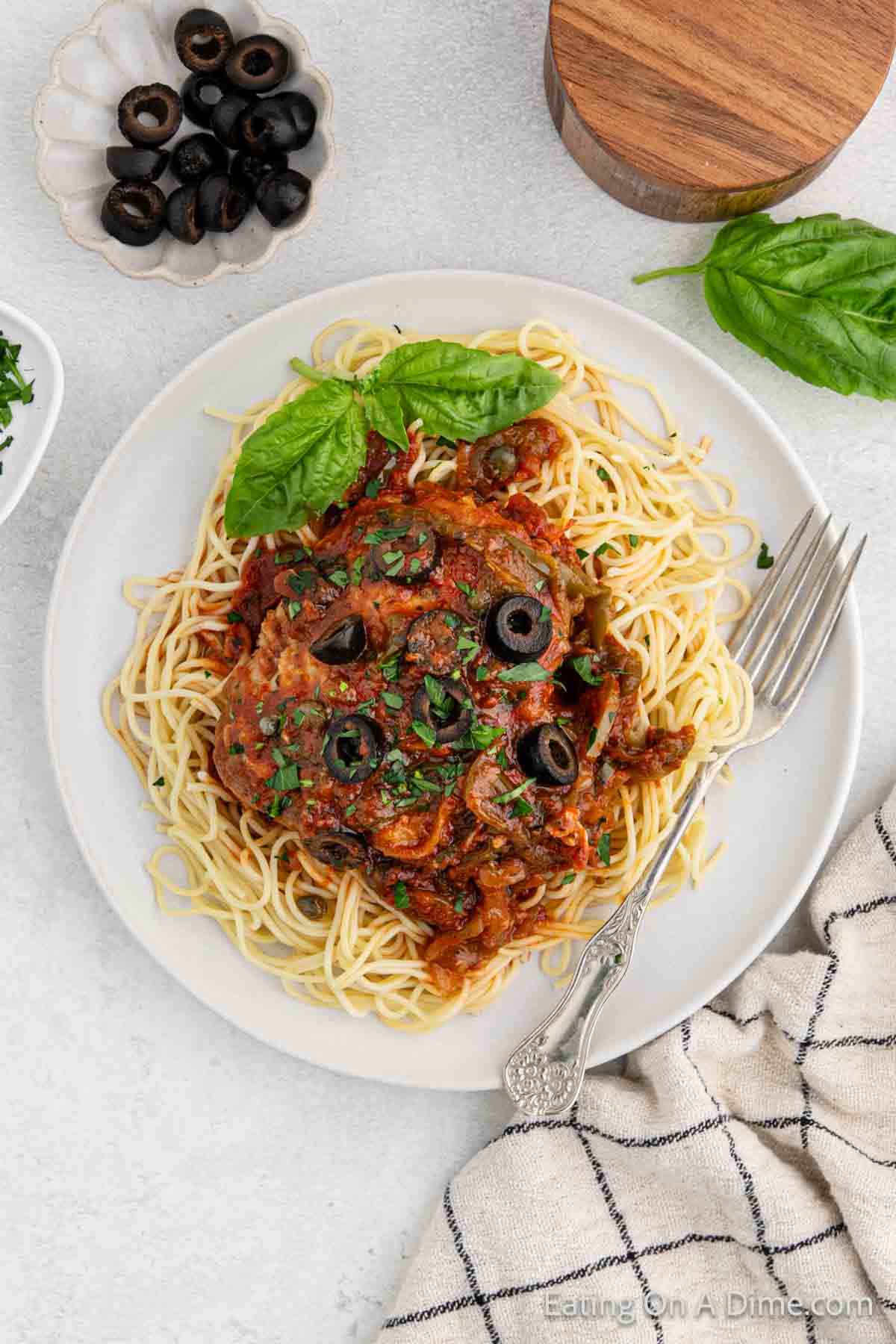Chicken cacciatore on a plate with spaghetti noodles