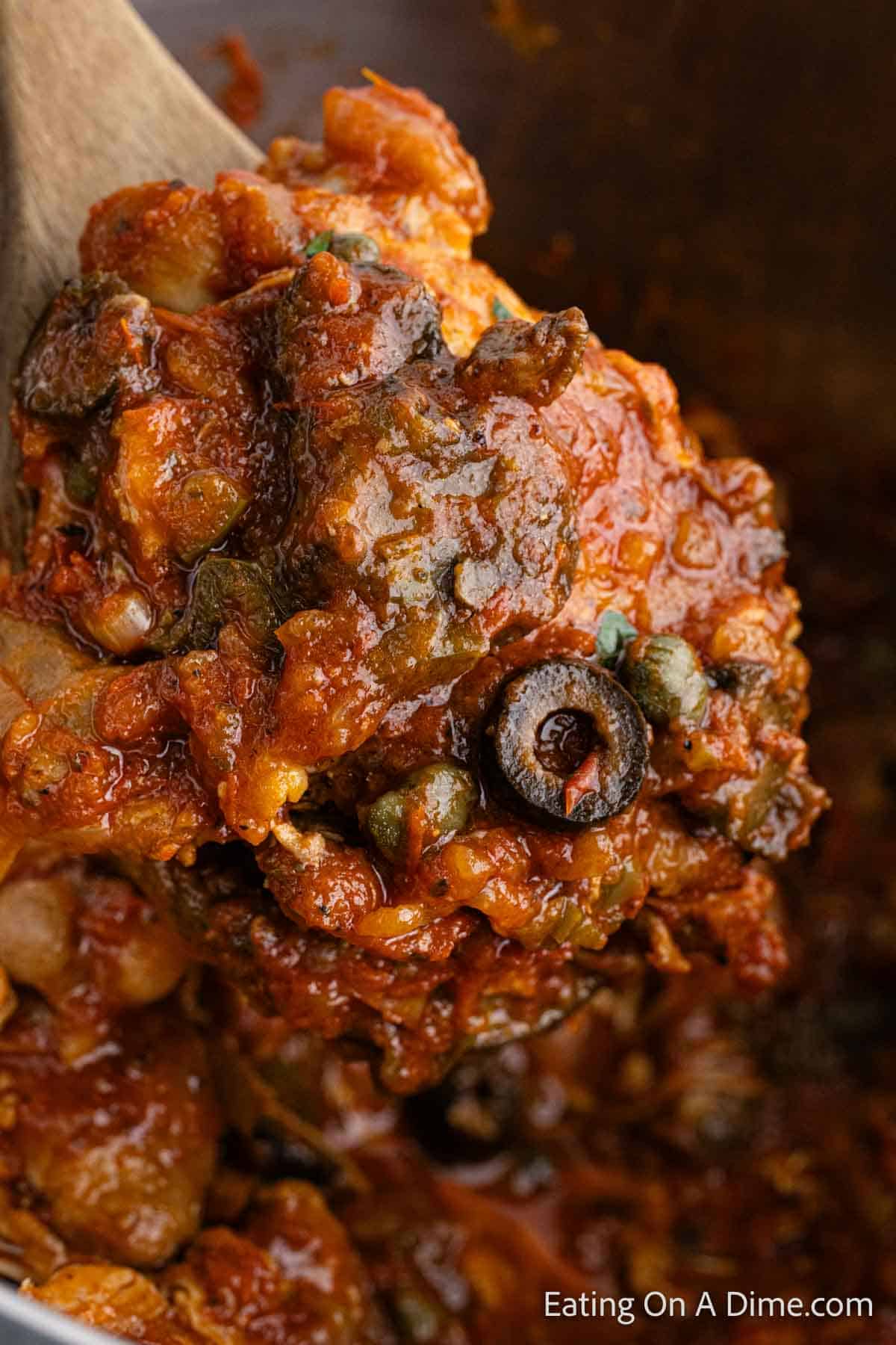 Close up image of Chicken Cacciatore on a wooden spoon