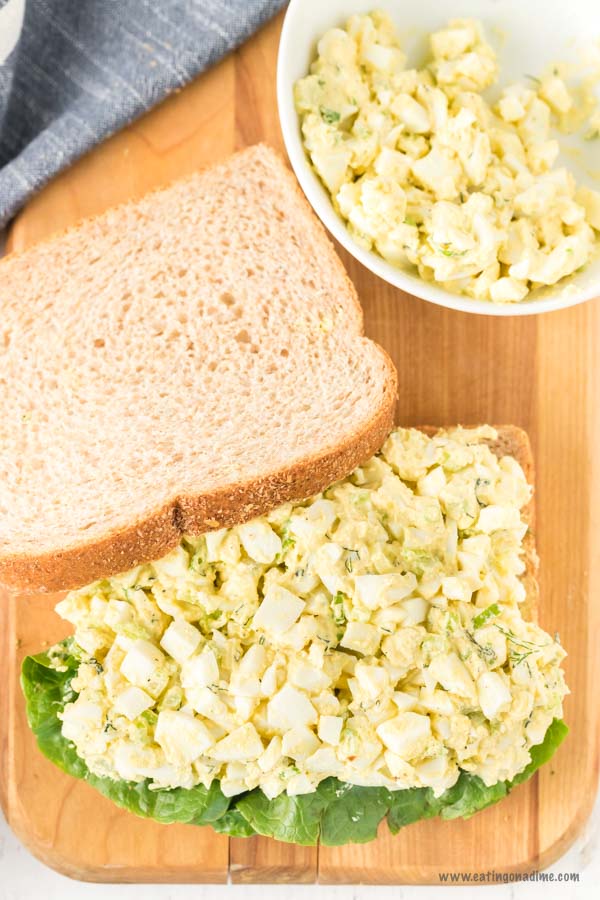 Egg Salad on a cutting board with a bowl of egg salad
