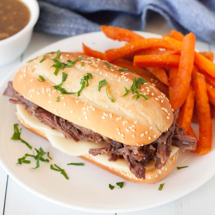 Crock pot shredded beef sandwiches will make dinner so easy and your family will love the tender and flavorful shredded beef. Come home to the best crock pot dinner ready to enjoy. Try Crockpot beef sandwiches for a crowd. #eatingonadime #crockpotshreddedbeefsandwiches #recipescrockpot #slowcooker