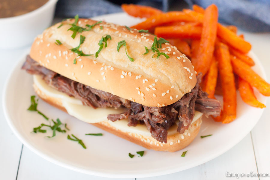 Crock pot shredded beef sandwiches will make dinner so easy and your family will love the tender and flavorful shredded beef. Come home to the best crock pot dinner ready to enjoy. Try Crockpot beef sandwiches for a crowd. #eatingonadime #crockpotshreddedbeefsandwiches #recipescrockpot #slowcooker