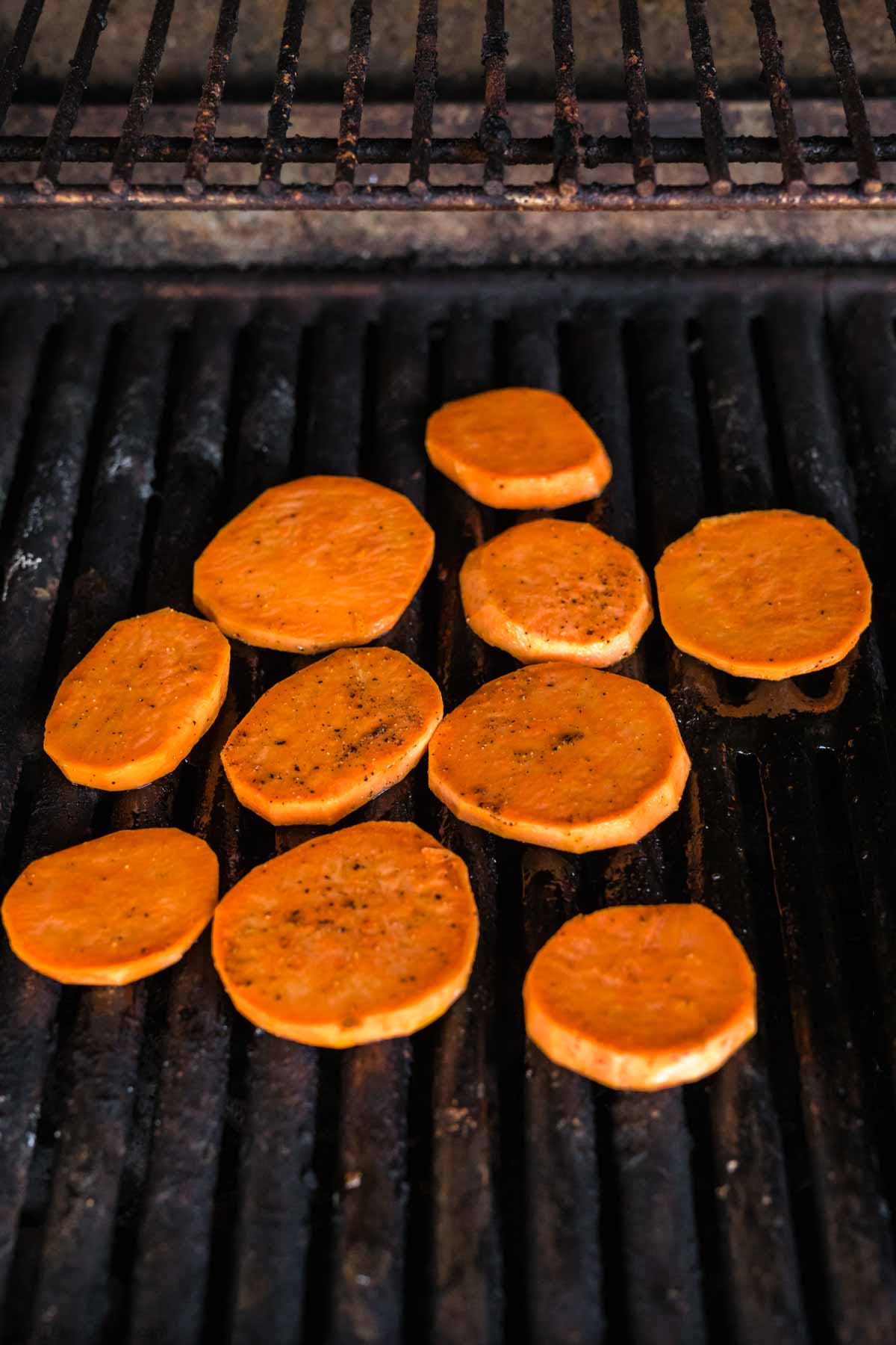 Placed sweet potatoes on a grill grates