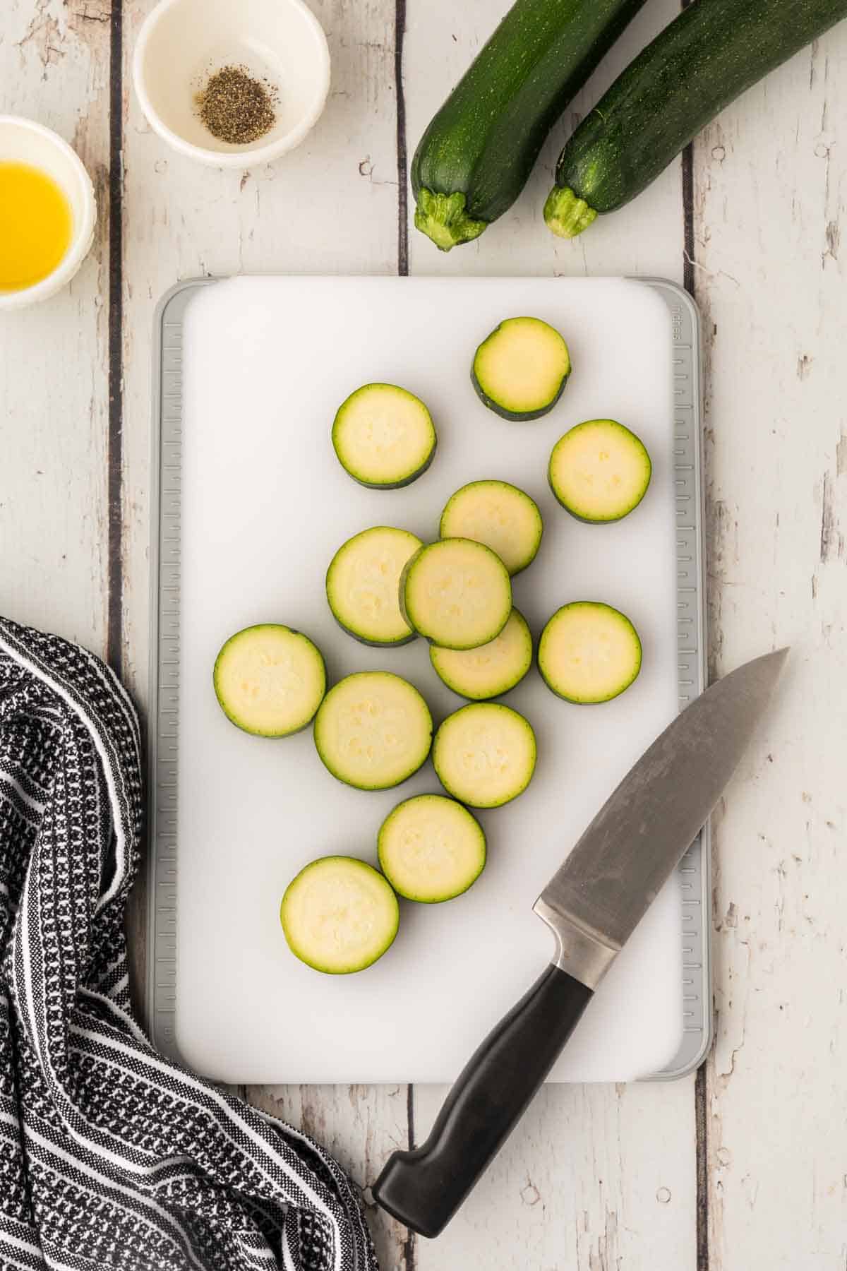 Slicing zucchini on a cutting board