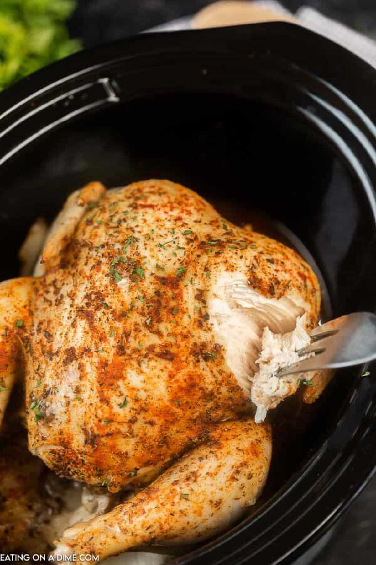 Cooked whole chicken in the slow cooker