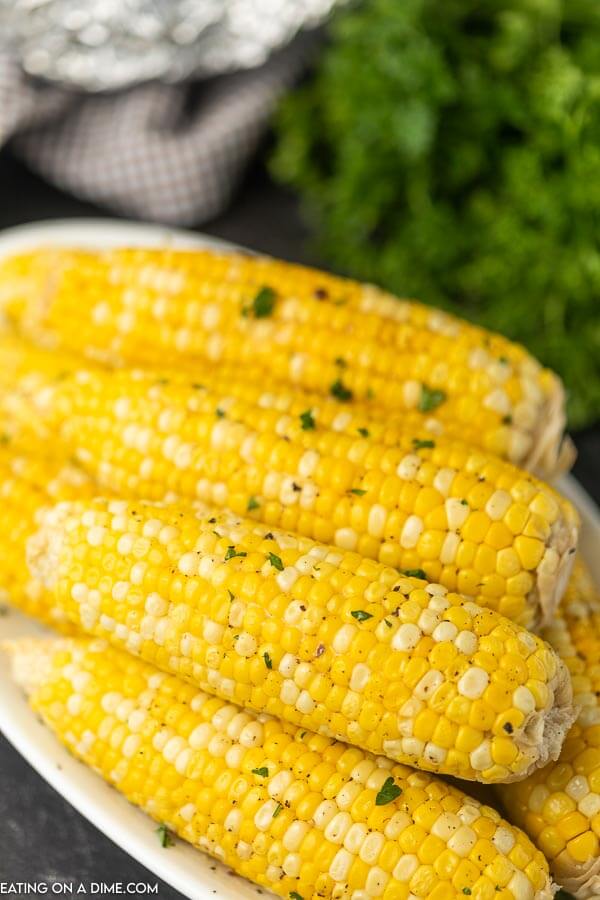 Grilled corn on the cob on a large platter. 