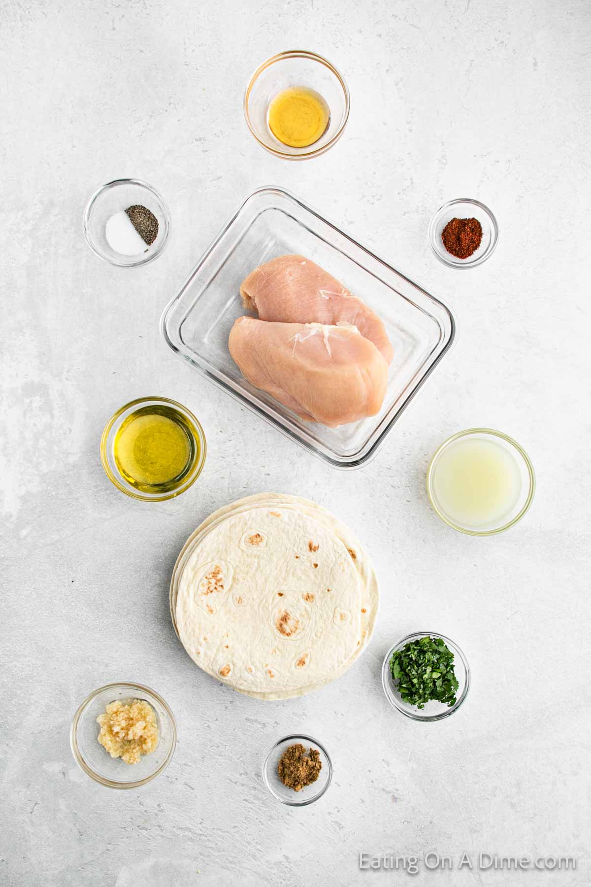 Cilantro Lime chicken tacos ingredients - chicken, limes, avocado oil, cilantro, garlic powder, honey, cumin, chili powder, salt, pepper, tortillas