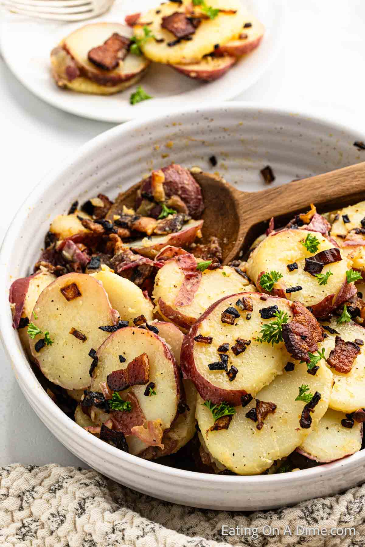 German Potato Salad in a bowl in a wooden spoon
