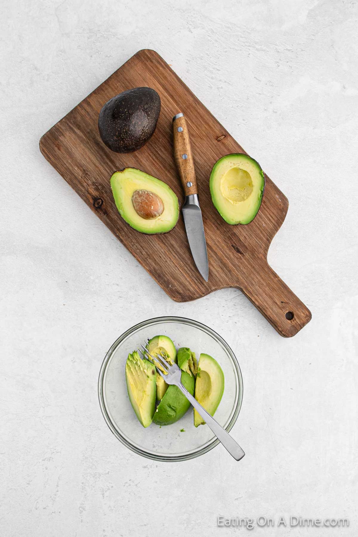 Slice avocados on a cutting board with a few in the a bowl